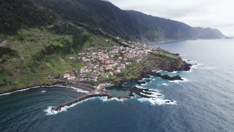 Rocky-cliffs,-with-small-town-in-Madeira,-Portugal