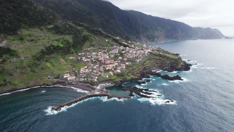 rocky cliffs, with small town in madeira, portugal