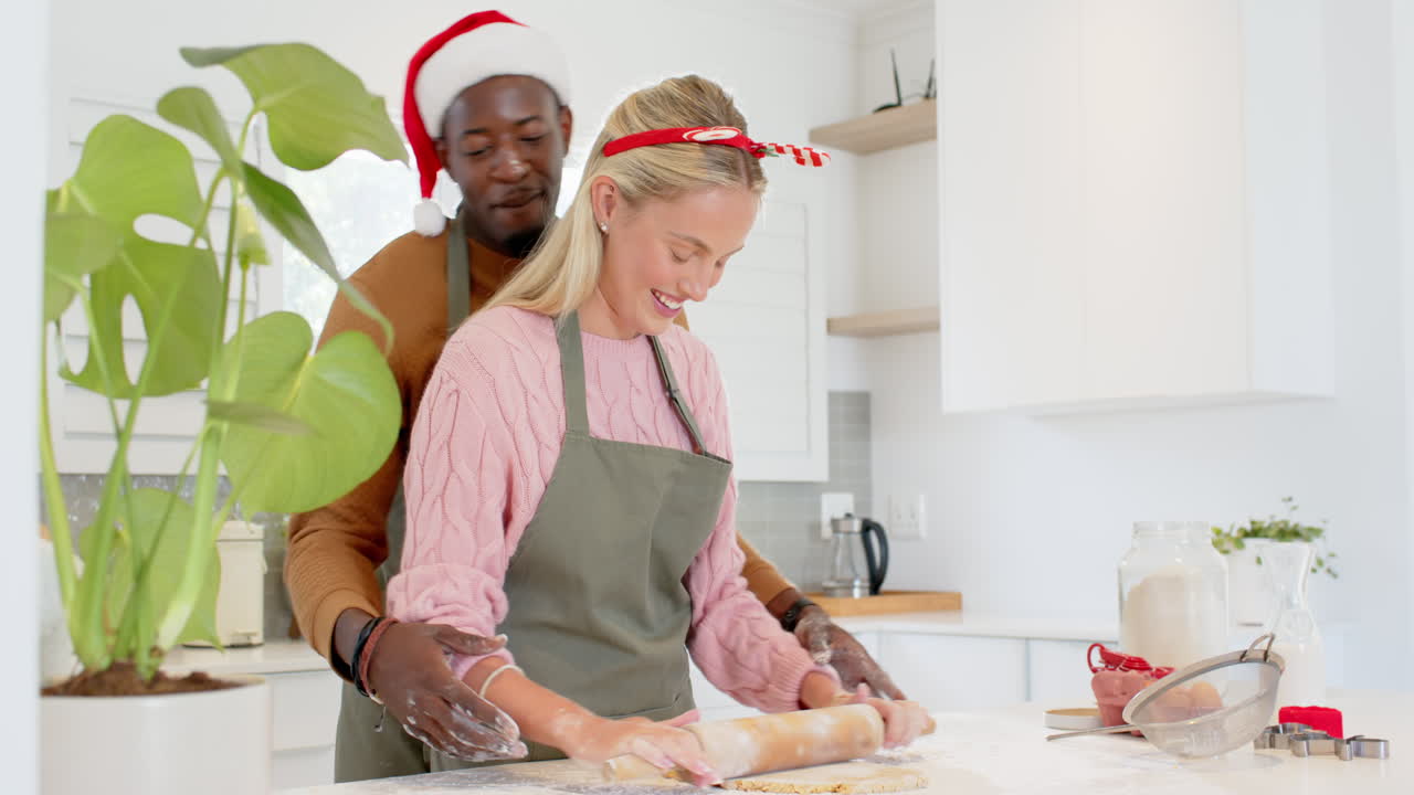 Christmas time, diverse couple baking cookies together in kitchen, holiday spirit, copy space