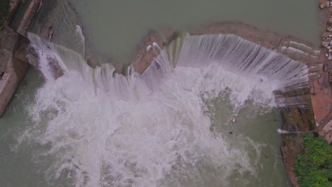 A breathtaking waterfall cascading between lush green mountains, showcasing the beauty of nature, flowing water, and the peaceful scenery of a pristine natural environment