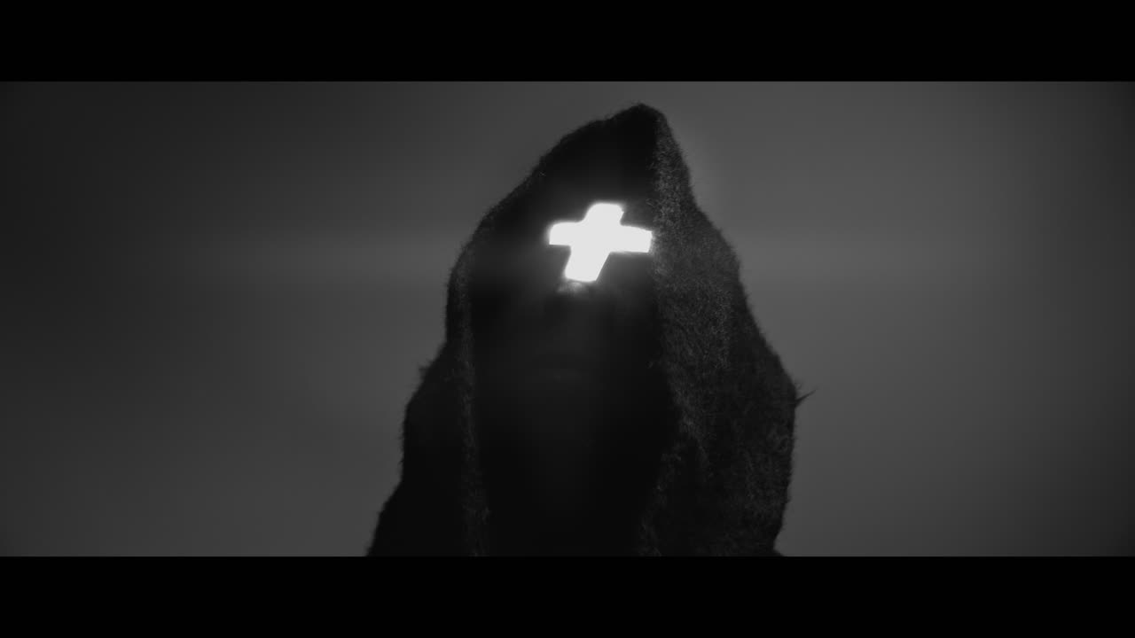 Masked man with cross of light glowing on his face moves his head up