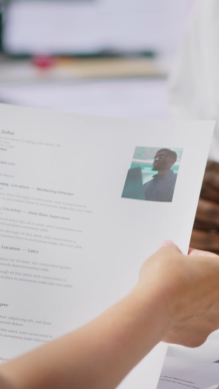 Vertical Video Job candidate hands over his CV to team of HR professionals to start interview