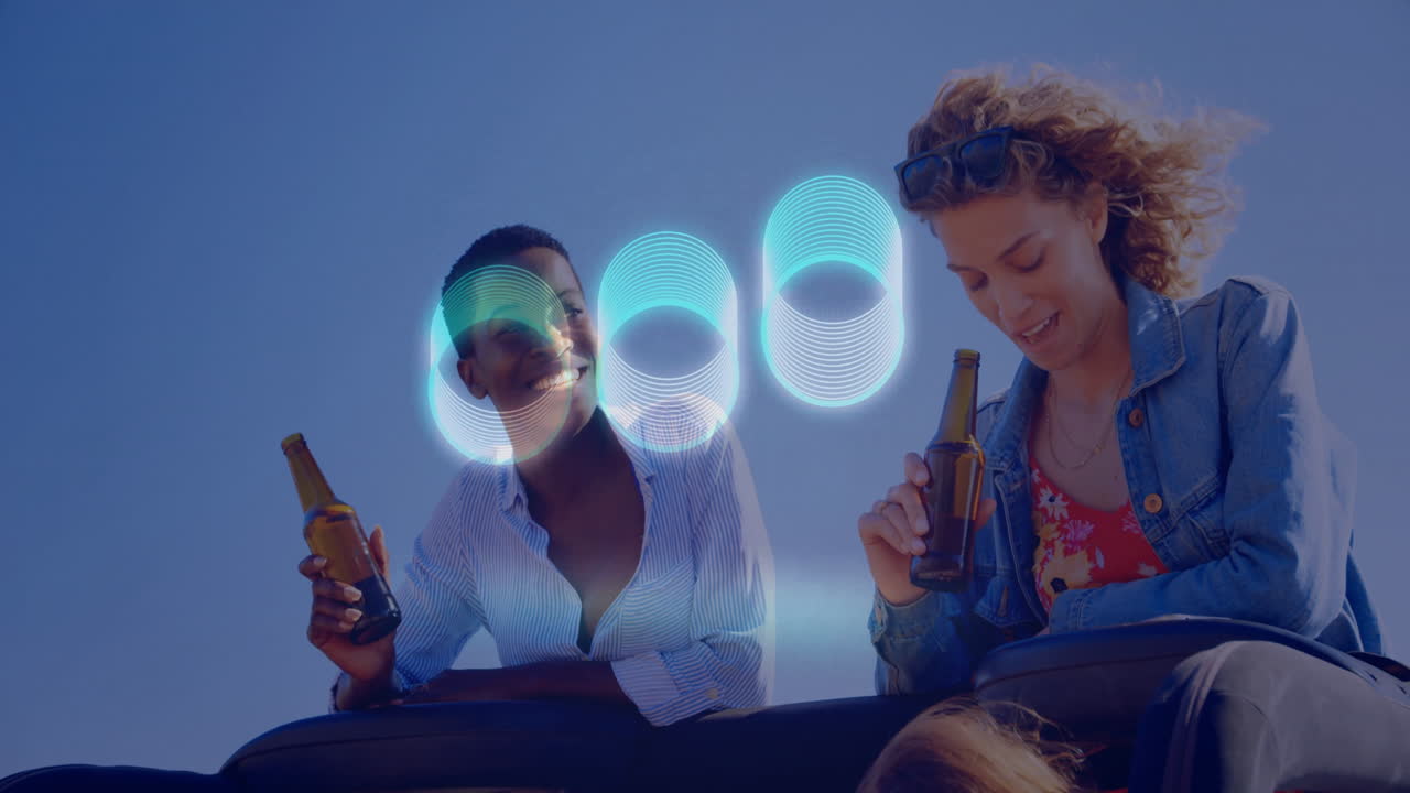 People enjoying drinks on rooftop with glowing blue circles animation above
