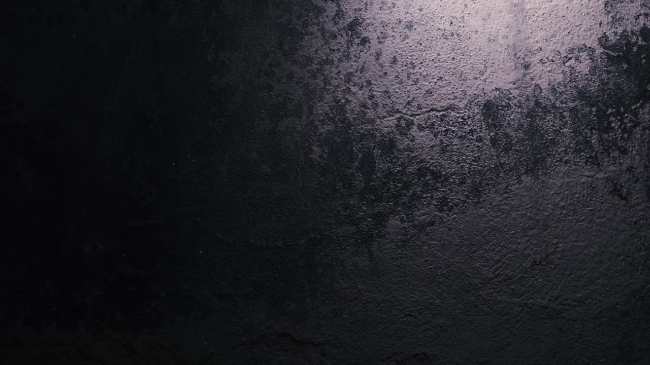 Moving bulb casting light beam across grunge wall. Dramatic scene perfect for fear, pursuit, or crime thriller narratives