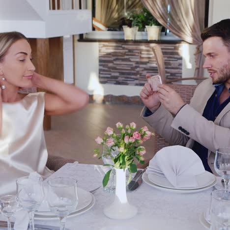 Man-Photographs-Woman-in-Restaurant