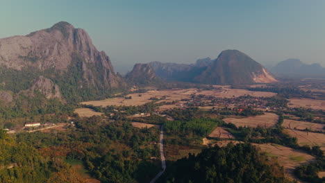 aerial view of a rural valley with mountains and rice paddies