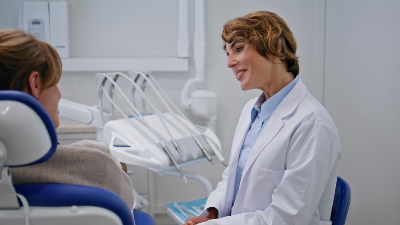Doctor consulting dental health in stomatology clinic closeup. Woman dentist