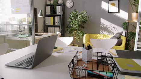 desk with office supplies and laptop