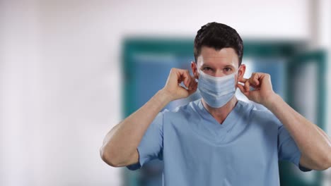 portrait of male caucasian health worker wearing face mask in hospital