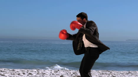 handsome businessman boxing on the beach