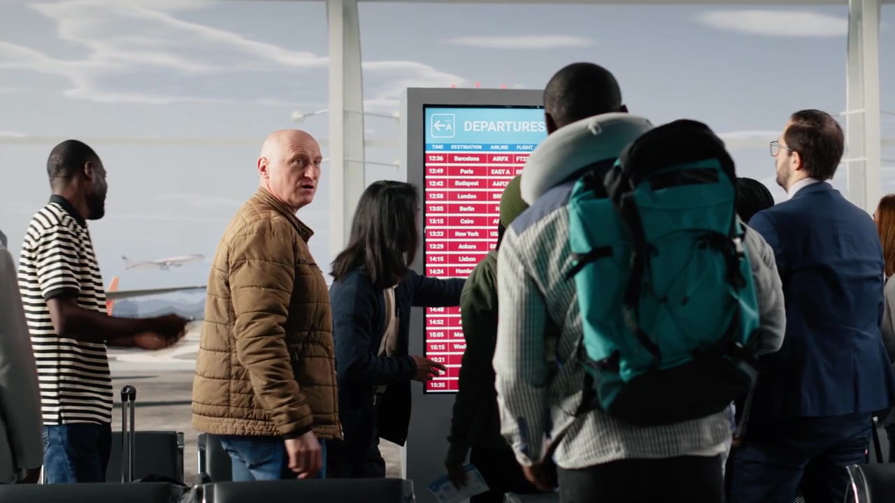 Angry passengers in airport seeing red on departure board caused by flight delay