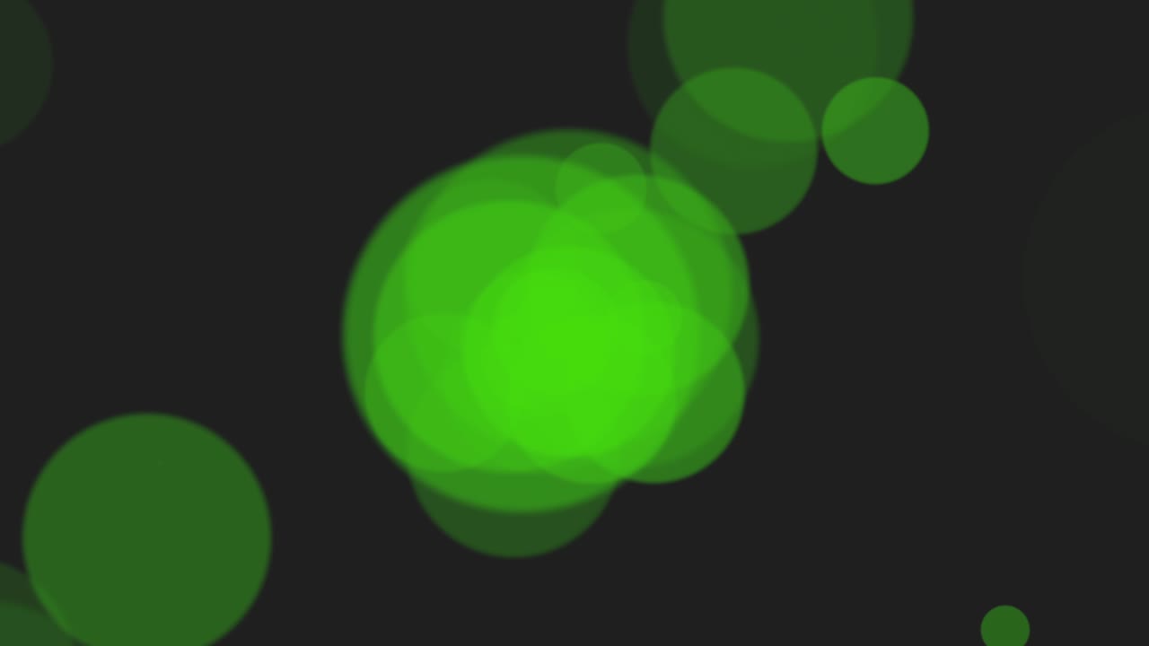 Green particles and round bokeh on shiny background