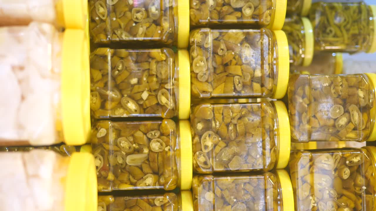 Stacked Jars of Pickled Green Chili Peppers