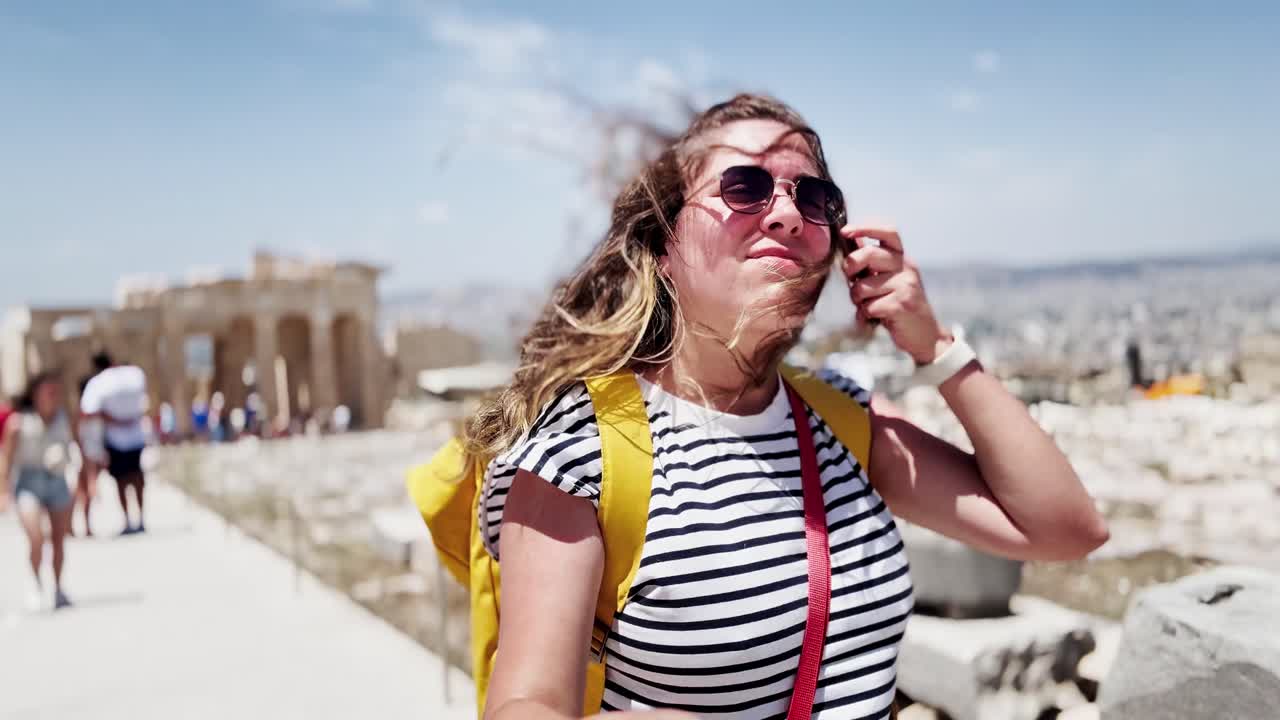 Woman Vlogging Among a Crowd of Tourists at Acropolis, Athens, Greece
