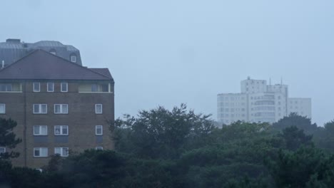 a slow motion shot through a window covered with rain drops in bournemouth, england