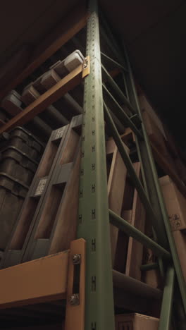 a close-up shot of a green metal frame supporting shelves in a warehouse