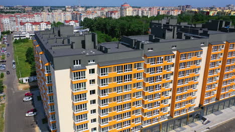 exterior of modern architecture in the city. new apartment building with colorful walls and grey roof. residential block of flats newly built. aerial view.
