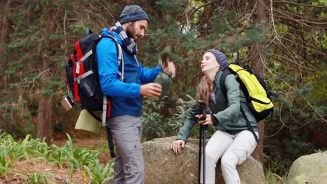 hiker couple interacting with each other in forest