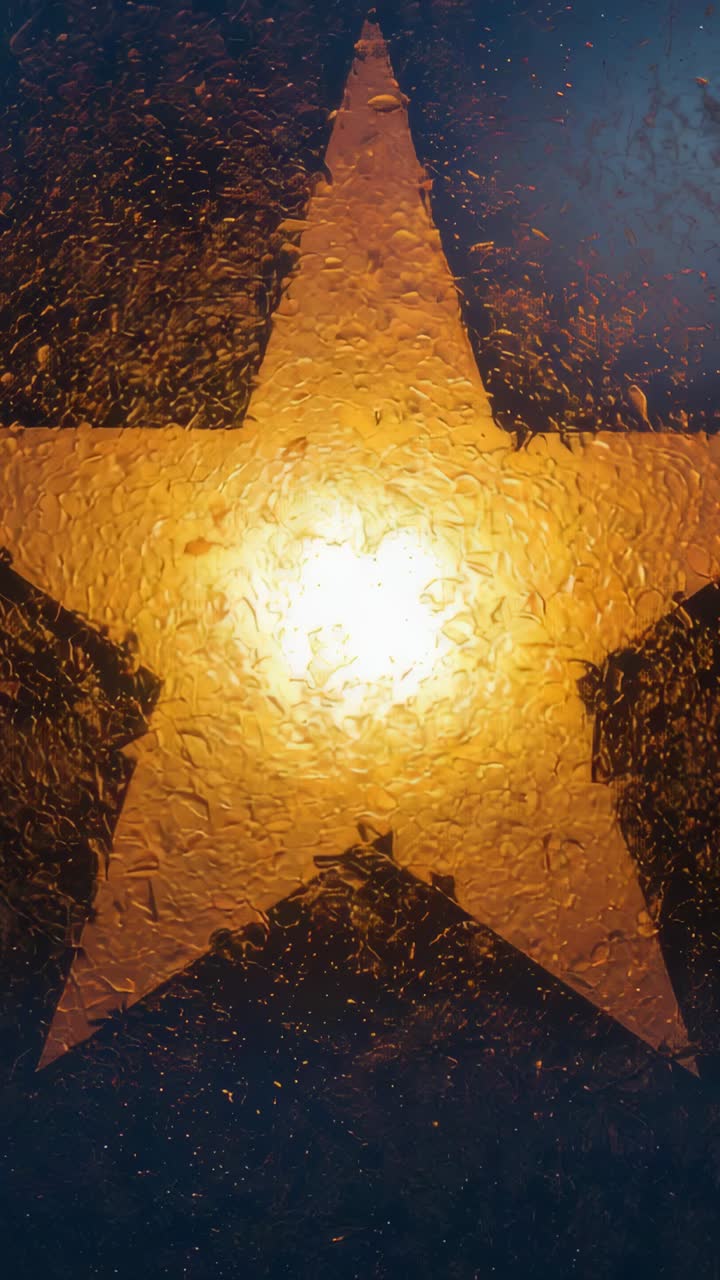 Vertical video: Glowing star emitting white-gold halo through wet pane at night, raindrops shifting