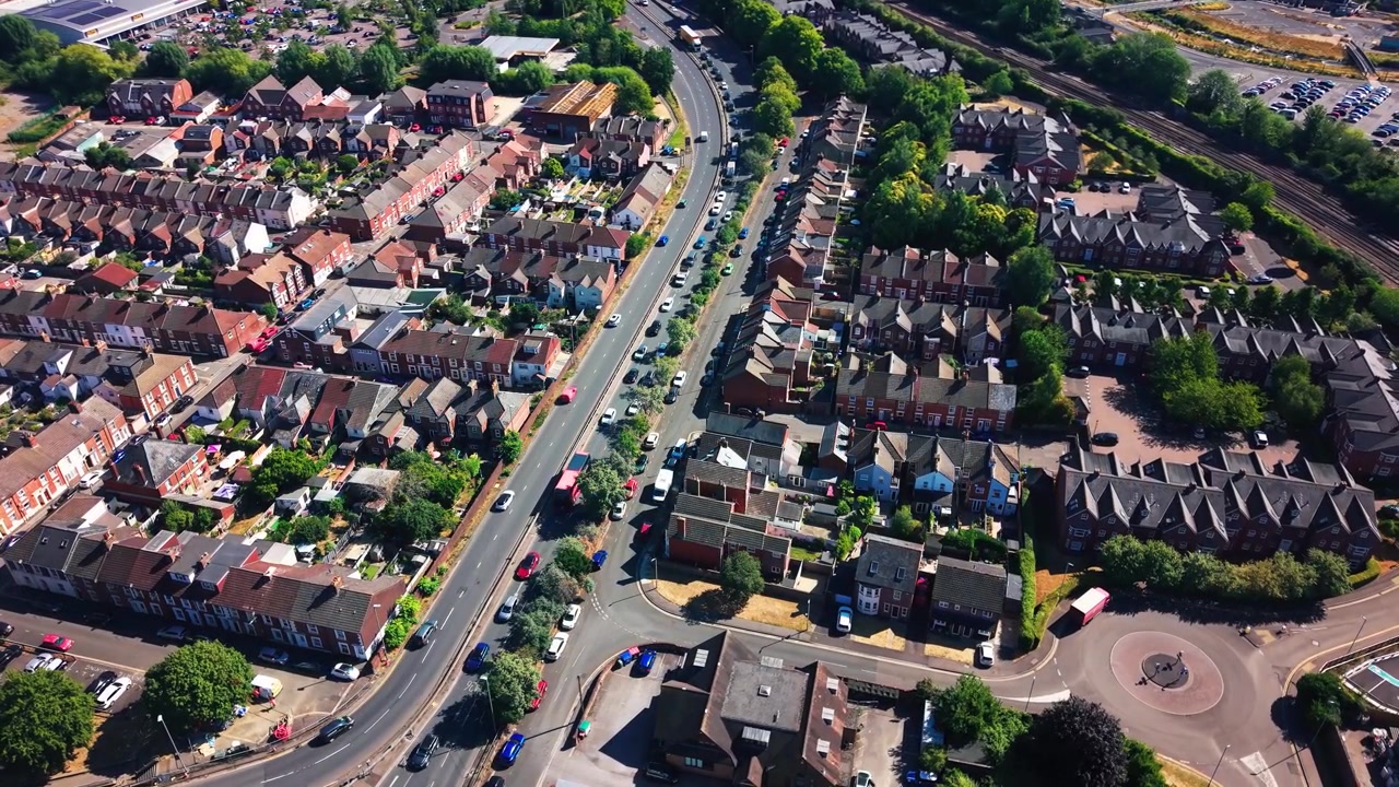 Høyt luftfoto over boligområdet Salisbury som viser A360 Devizes Road, rekkehus, trafikk, grøntområder og nærliggende jernbanespor.