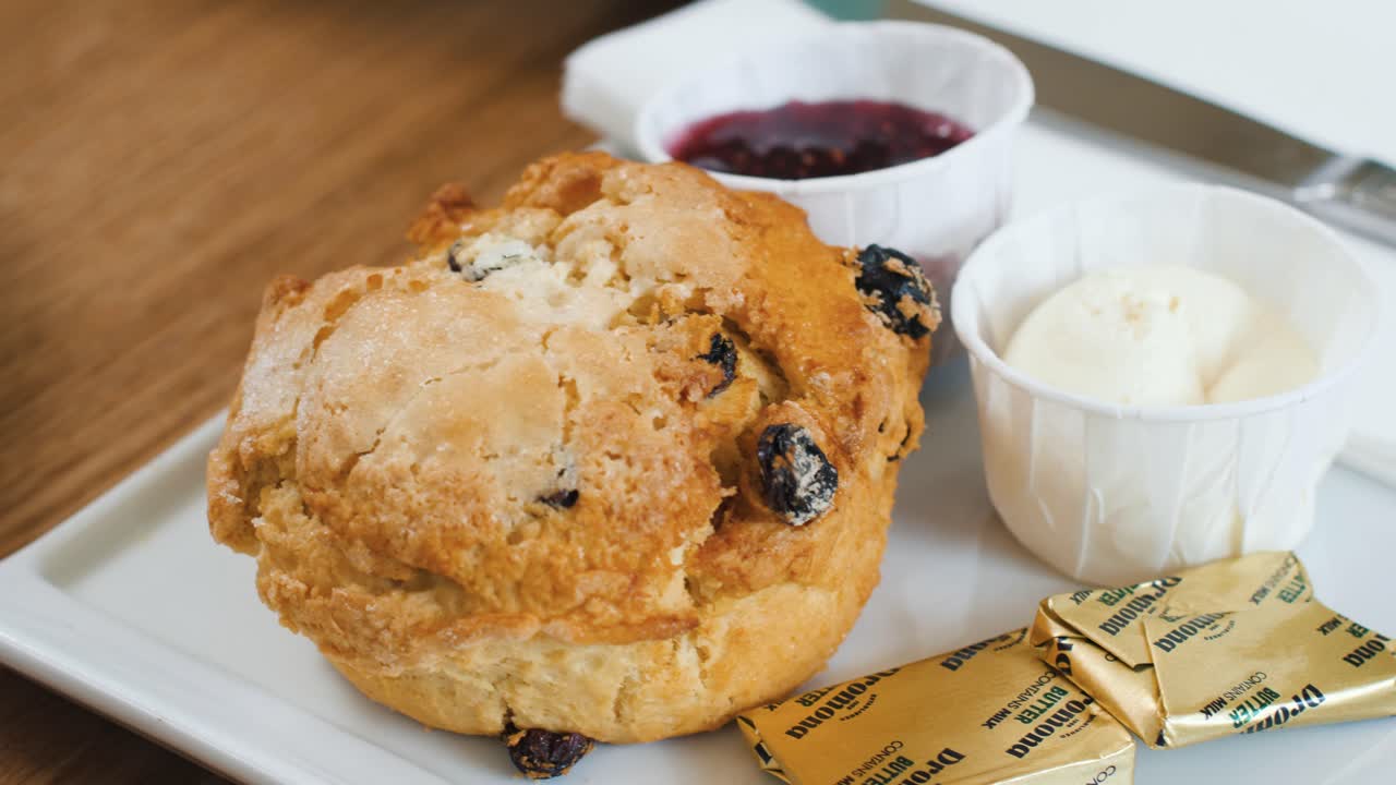 A delicious scone with jam and butter