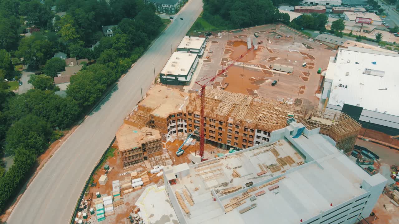 Epic drone footage of an active construction site with oncoming traffic nearby