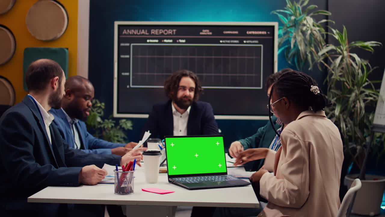 Product management team developing strategies with mockup display