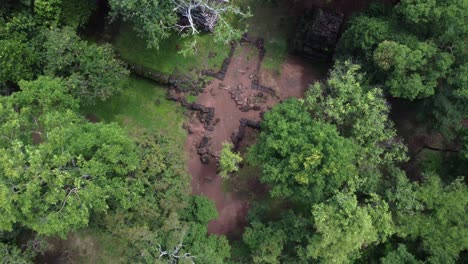 jungle aerial rises over ancient stonework at overgrown koh ker temple