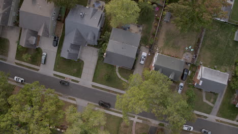 overhead view of houses in the suburbs on a fall day with scroll up