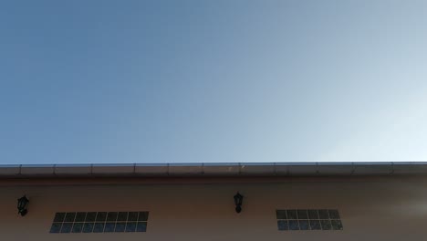 bright morning sun light ray shining on sunrise blue sky over house roof top