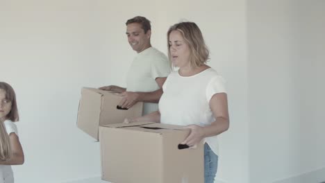 family couple and two kids moving into new apartment