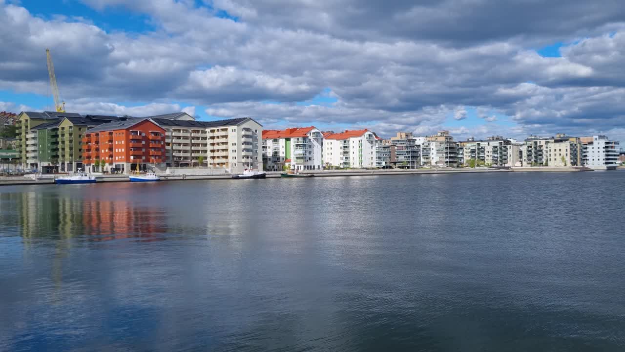 View of the delta where the Selångersån River meets the Sundsvall Bay in Västernorrland County, Sweden, with homes along the water and Sundsvallsbron bridge on the horizon