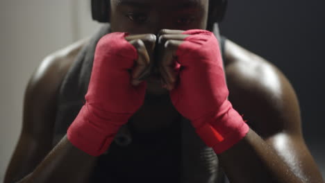 a young man using headphones in the locker room