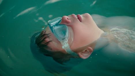 close-up shot of safety goggles backstrokes on the freshwater lake