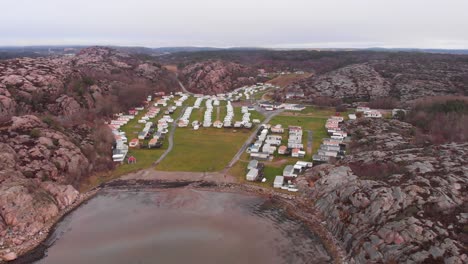 lysekil, sweden - a community situated near the lake beneath the rocky mountains - wide shot