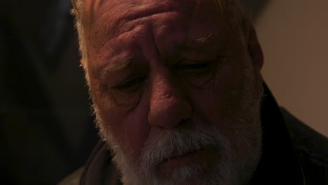 An-elderly-male-man-looking-sad-and-about-to-cry,-deep-in-thought