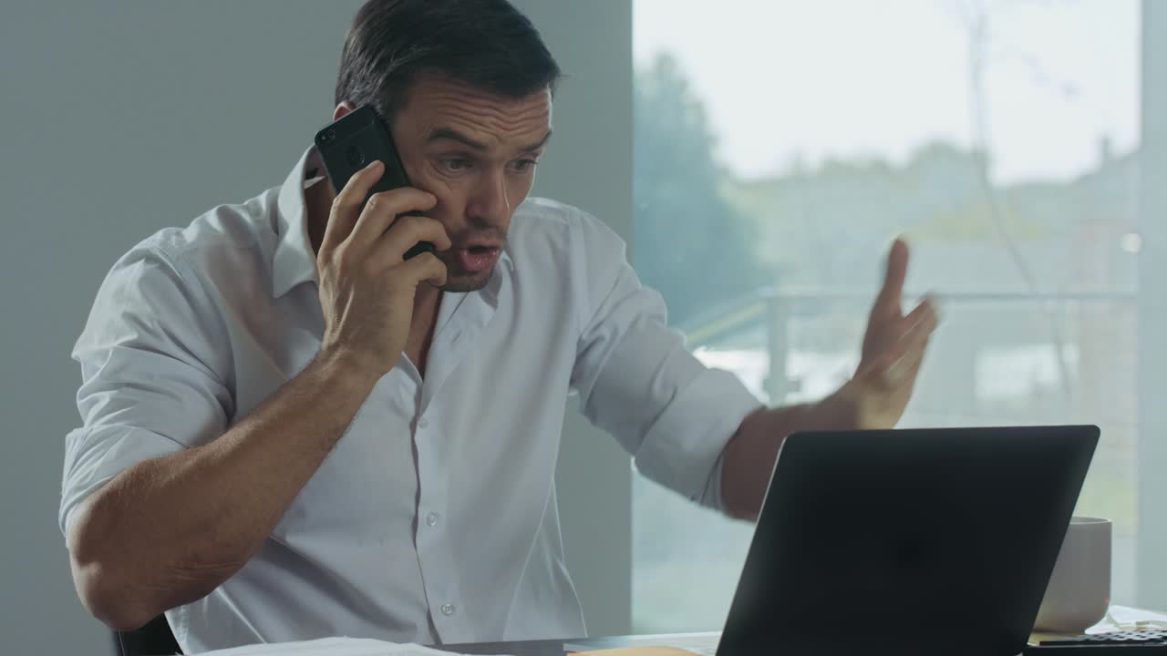 Business man talking mobile phone for work. Angry freelancer making phone call.