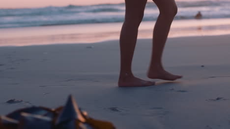 close up woman feet walking barefoot on beach at sunset leaving footprints in sand female tourist on summer vacation