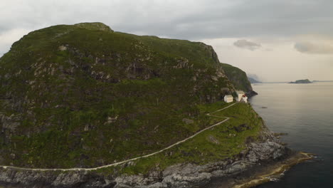 Scenic-View-Of-Hendanes-Lighthouse-On-The-Western-Shore-Of-The-Island-Of-Vagsoy-In-Norway---aerial-shot