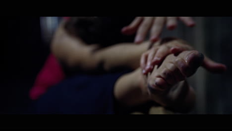 a young woman practices modern dancing and ballet in a moody room full of mirrors