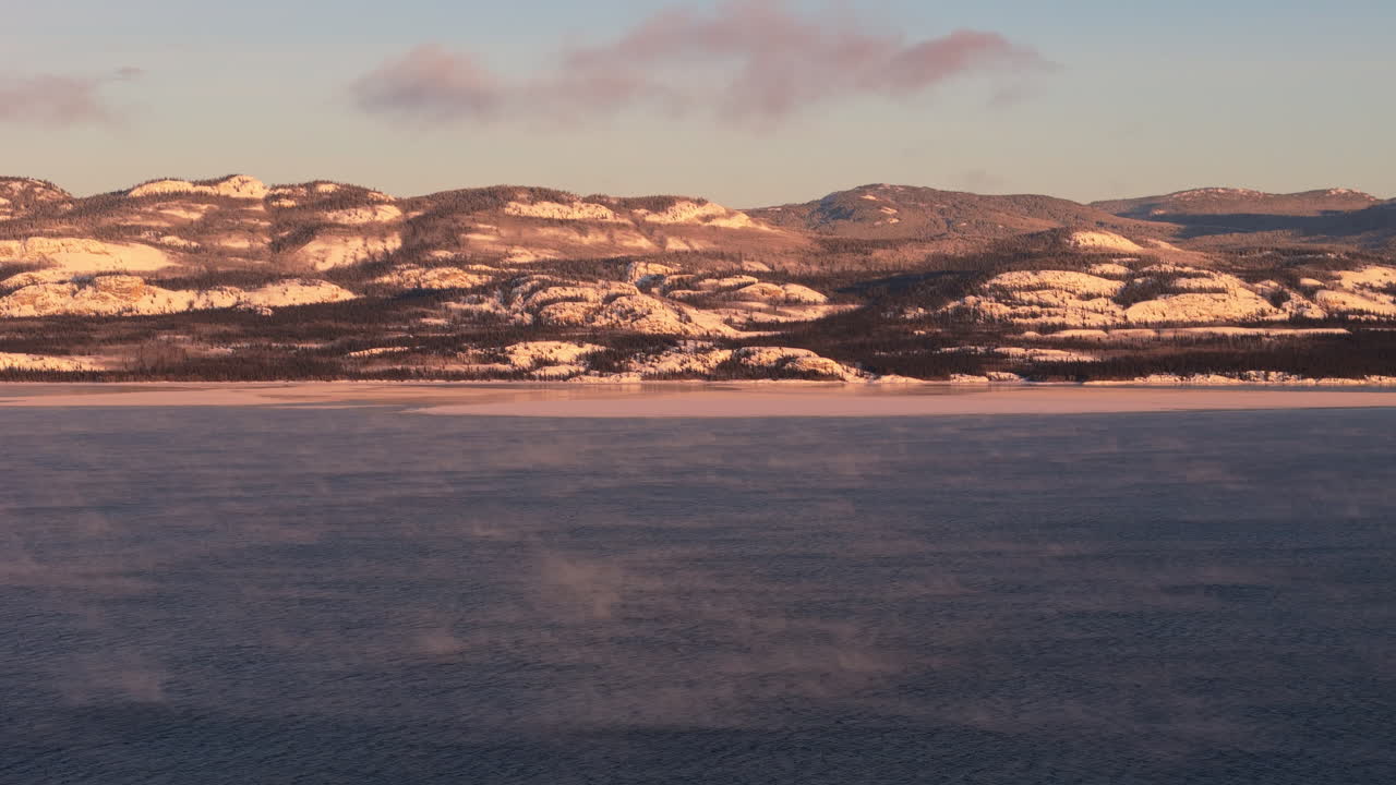 Panorama Of Snowy Mountain And Lake Laberge During Winter In Yukon, Canada. - wide shot