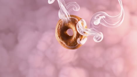 floating donut in pink smoke