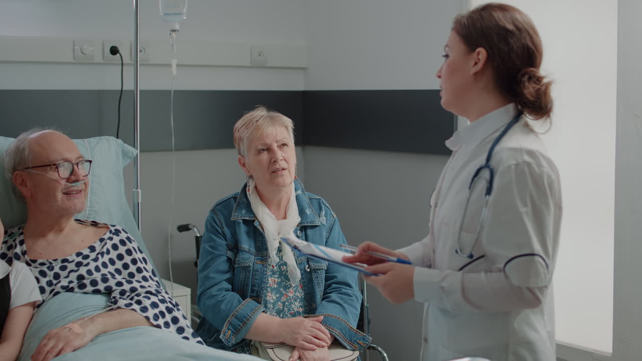 Close up of physician consulting ill patient with family in visit