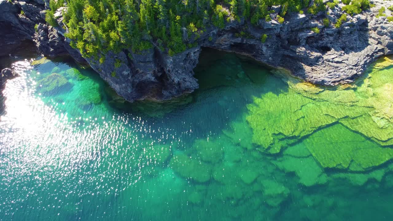 Bird's eye view of the clear waters of Lake Huron and the rocky cliffs on its banks