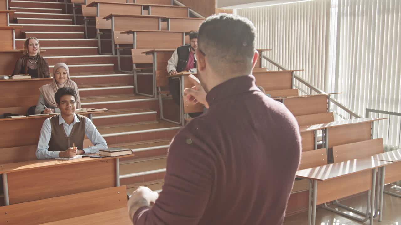 Male University Professor Talking to Students during Seminar