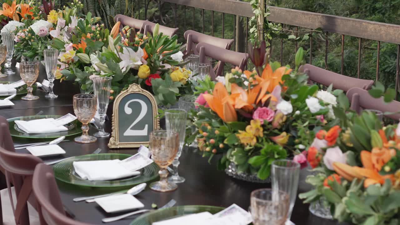 Wedding banquet table with colorful floral centerpieces