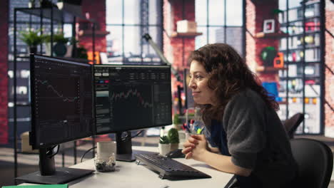 joyful thrilled woman works on stock trading analysis browsing real time data