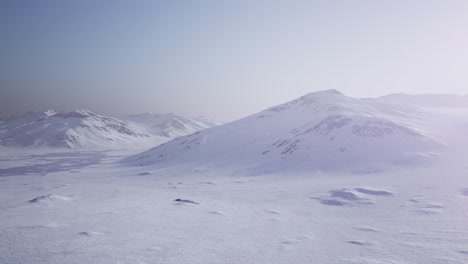 aerial landscape of snowy mountains and icy shores in antarctica