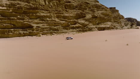 4x4 pickup car driving in the desert towards wadi rum in jordan