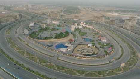 Aerial-drone-shot-of-amusement-park-in-and-surrounding-highways-in-Bahria-Town,-Karachi,-Pakistan